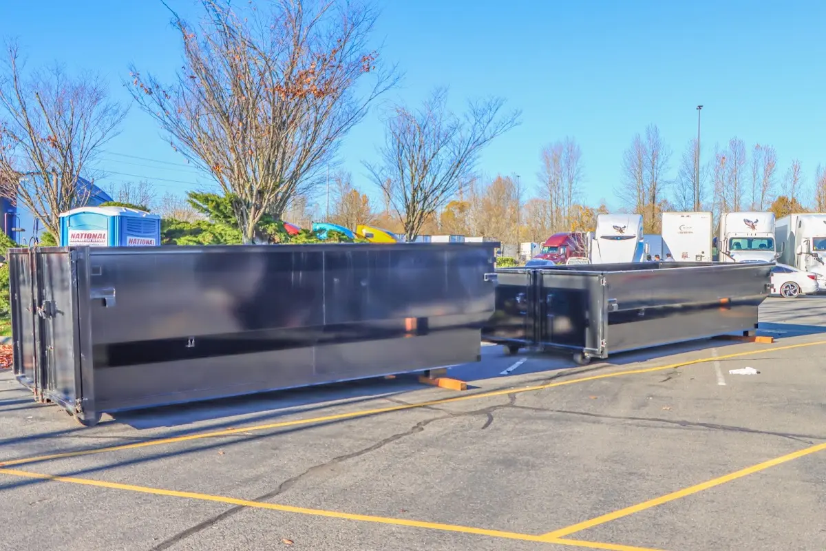 Professional dumpster rental service with roll-off container on residential driveway in North Platte